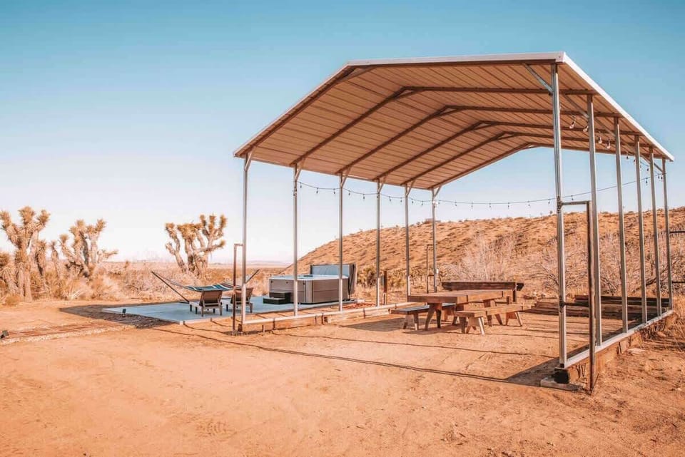 Homestead converted parking hanger with outdoor dining and string lights overhead