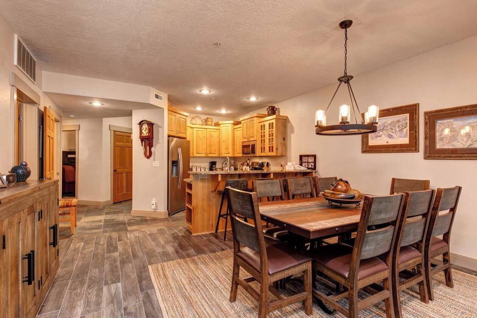 Dine together at the wooden table for eight, perfectly placed between the kitchen and living area for effortless flow and connection.