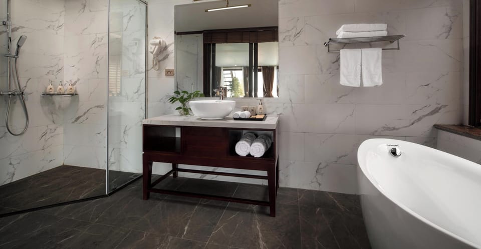 Separate tub and shower, hair dryer, slippers, towels