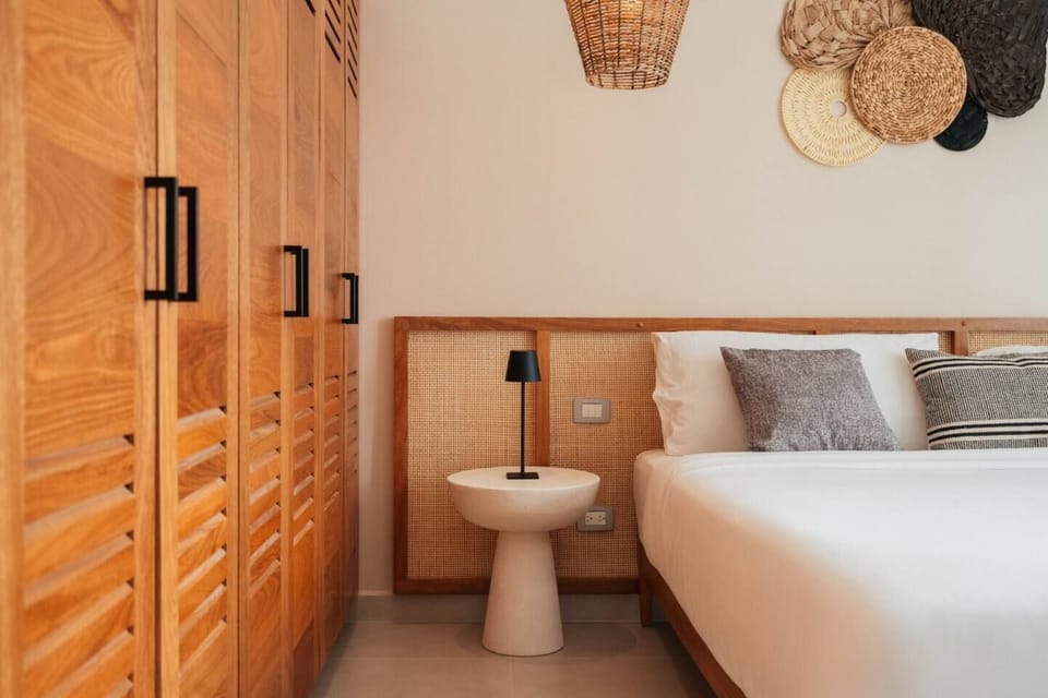 Bedroom 1 with a comfortable king bed, bedside table, and plenty of wardrobe storage.