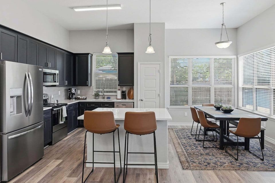 A fully equipped chef's kitchen with everything you need for a home-cooked meal or game day prep. Breakfast bar, full-size appliances, cookware, utensils, and counter space to spare — because not every great meal should come from DoorDash.