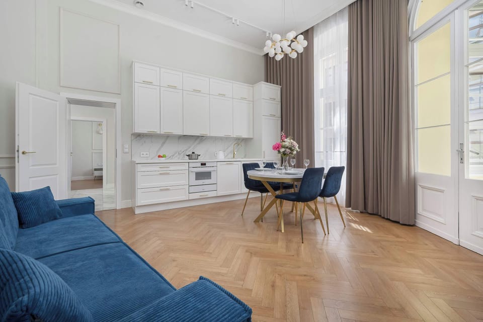 A bright open-plan interior combining a modern kitchen and lounge area.