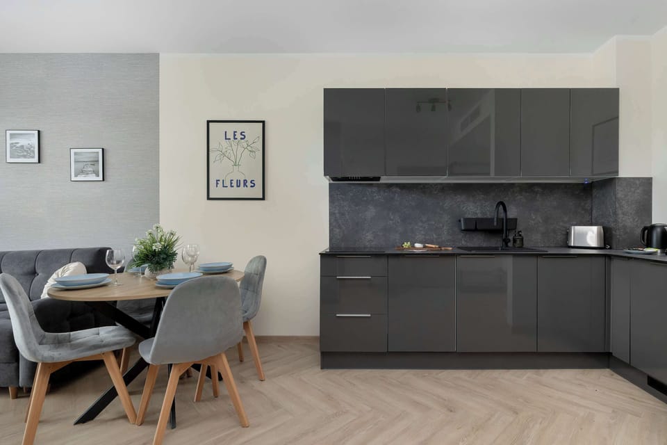 The sleek design of the kitchenette blending seamlessly with the living area.