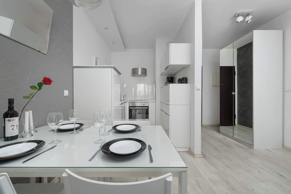 Modern dining area connected to the fully equipped kitchen and spacious apartment interior.