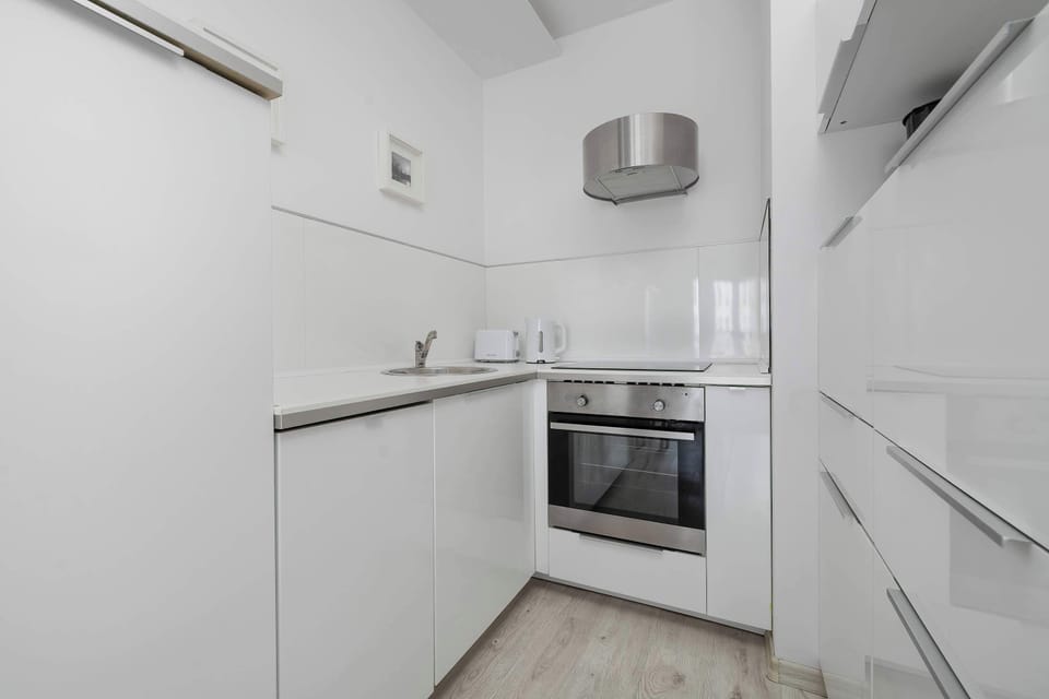 Fully equipped modern kitchen with oven, stovetop, and all essentials for home cooking.