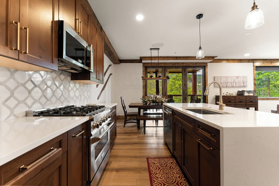 Your gourmet kitchen awaits, featuring rich wood cabinetry, sleek quartz countertops, and stainless appliances.