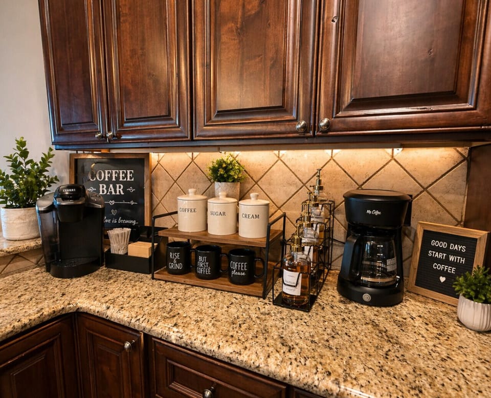 Charming in-home coffee bar with Keurig and drip brewer, stocked essentials, and granite counters—perfect for cozy mornings at your luxury lakehouse retreat.
