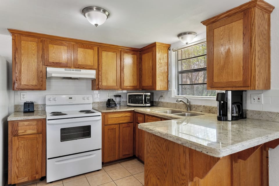 Spacious kitchen with ample cabinet storage, counter space, and a breakfast bar-style layout