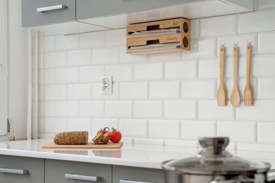 Kitchen countertop detail with white subway tiles and utensils