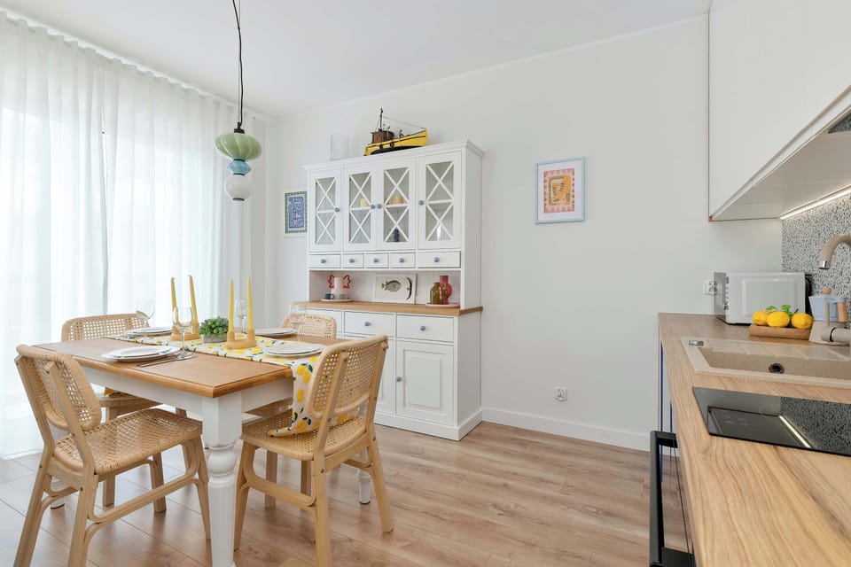 Bright kitchen with dining table and white cabinetry