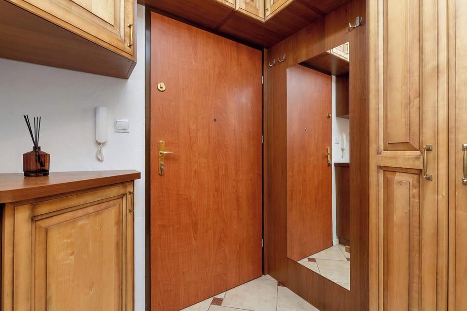 Wooden entrance hallway with built-in storage and mirror
