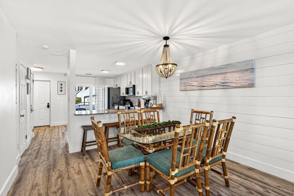 Gather around the spacious dining table under the statement chandelier, where meals turn into memories. The open-concept kitchen flows seamlessly, making hosting effortless and fun.