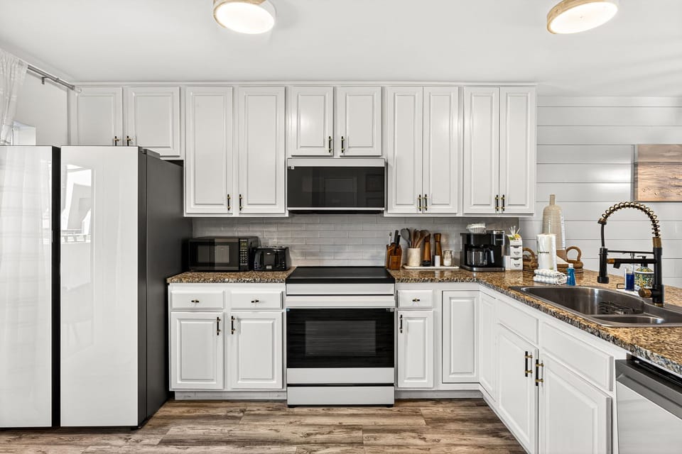 Your fully equipped kitchen features granite countertops, modern appliances, and plenty of space for preparing meals during your stay.