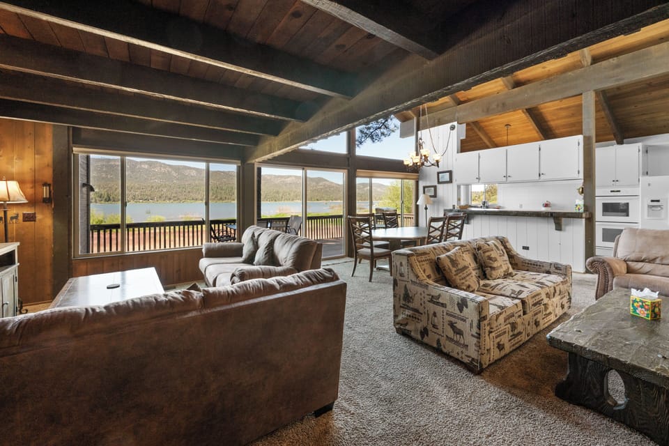 Living Room - Living Room with smart TV, wood fireplace, comfy couches, and vaulted ceilings.