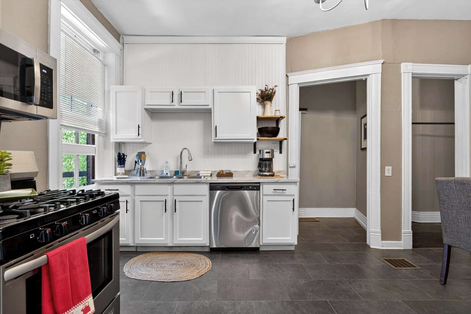 Kitchen: Bright, functional kitchen featuring a full-size stove, refrigerator, microwave, and well-stocked cabinets that make cooking feel easy and enjoyable