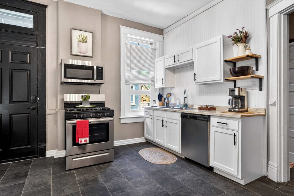 Kitchen: Bright, functional kitchen featuring a full-size stove, refrigerator, microwave, and well-stocked cabinets that make cooking feel easy and enjoyable