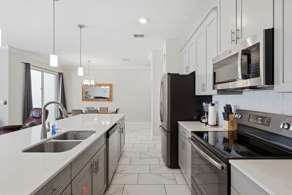 Fully stocked modern kitchen with oversized island seating perfect for family breakfasts and late-night snacks.