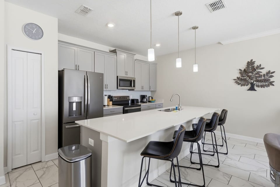 Clean, contemporary kitchen featuring stainless steel appliances and plenty of prep space for group meals.