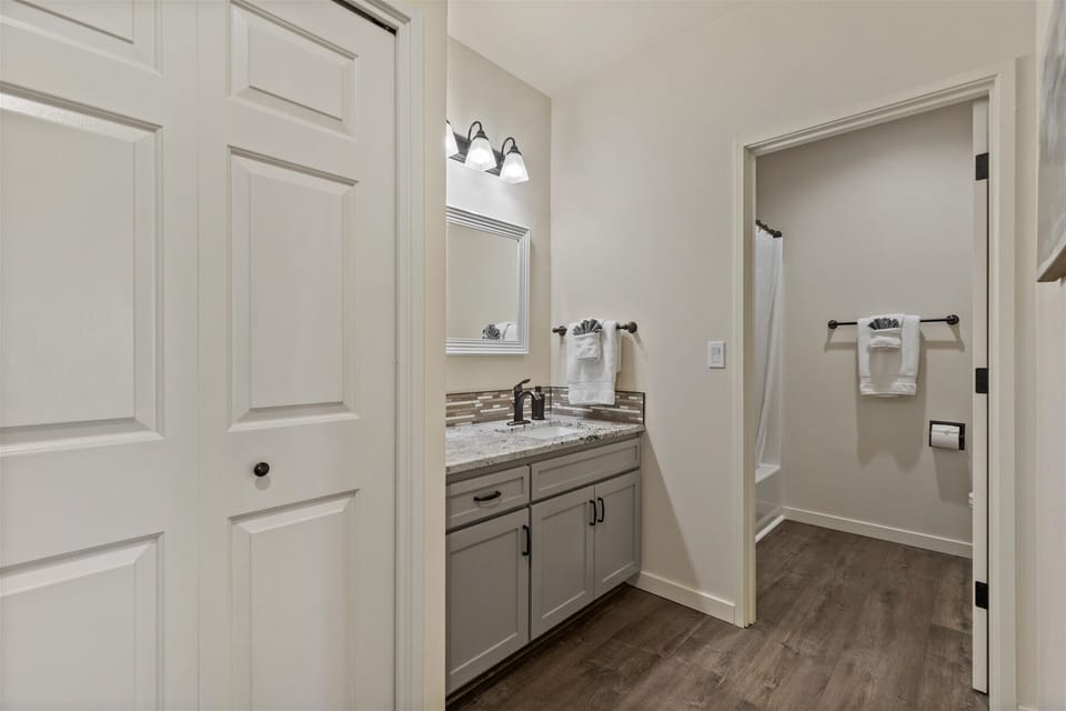 Full bathroom with convenient tub/shower combo and modern finishes.