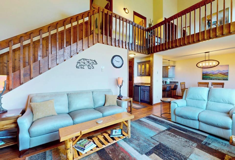 Step into your spacious mountain retreat featuring a dramatic lofted design, warm wood accents, and comfortable gathering spaces where your family can unwind after adventure-filled days in the highlands.