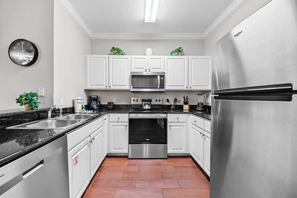 Experience a beautifully designed kitchen featuring stainless steel appliances and elegant granite countertops, creating an inviting space for culinary creativity with its bright layout, ample cabinetry, and tasteful decor.