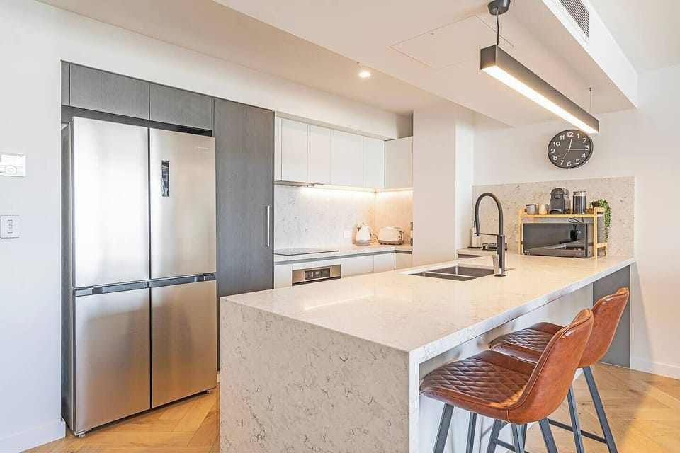 Gather around the stone kitchen bar for morning coffee or evening wine while preparing meals.