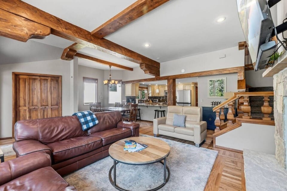Spacious living room with plenty of seating, smart TV, fireplace, and huge windows