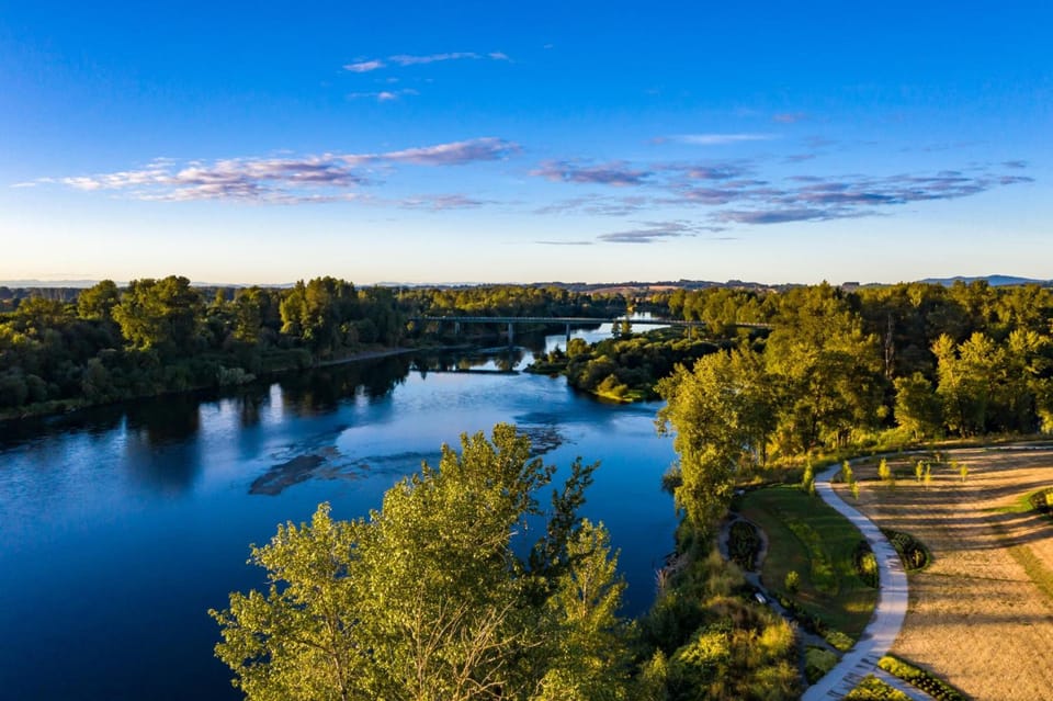 Wander nearby trails beside the river and distant bridge views.