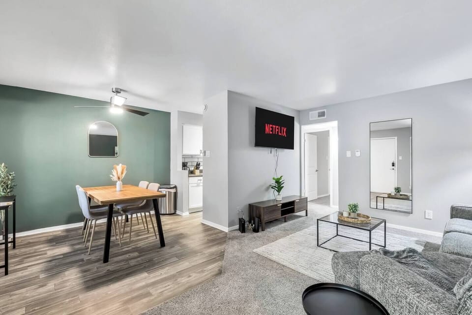 Spacious and inviting living area with comfortable seating and a smart TV, perfect for relaxing after exploring Arlington or attending events at AT&T Stadium.