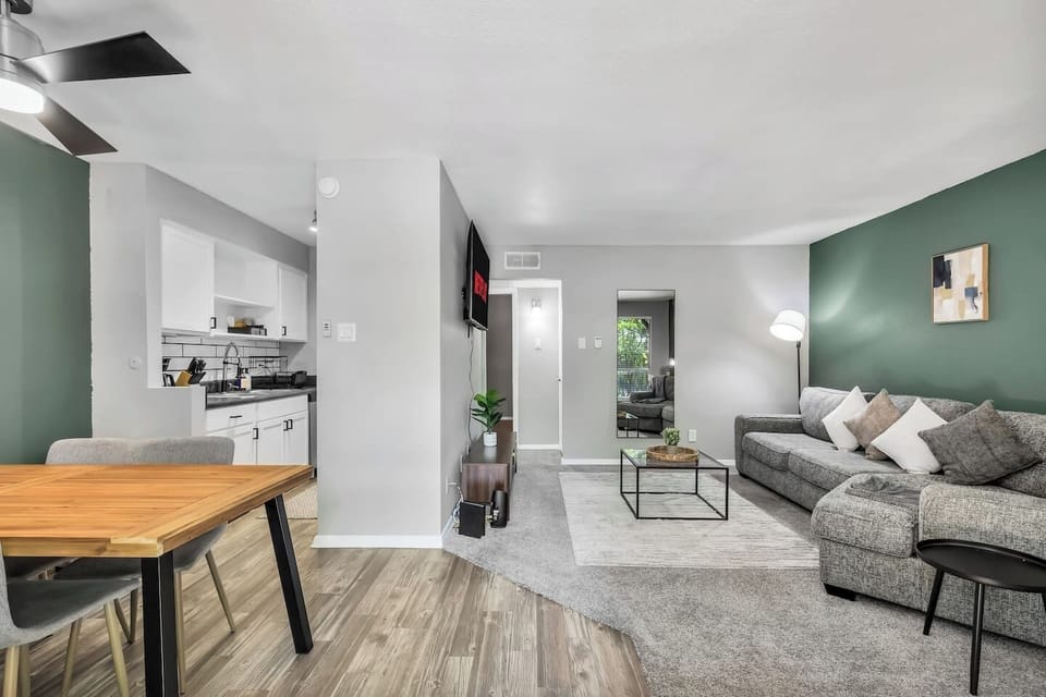 Spacious and inviting living area with comfortable seating and a smart TV, perfect for relaxing after exploring Arlington or attending events at AT&T Stadium.
