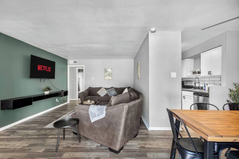 Spacious and inviting living area with comfortable seating and a smart TV, perfect for relaxing after exploring Arlington or attending events at AT&T Stadium.