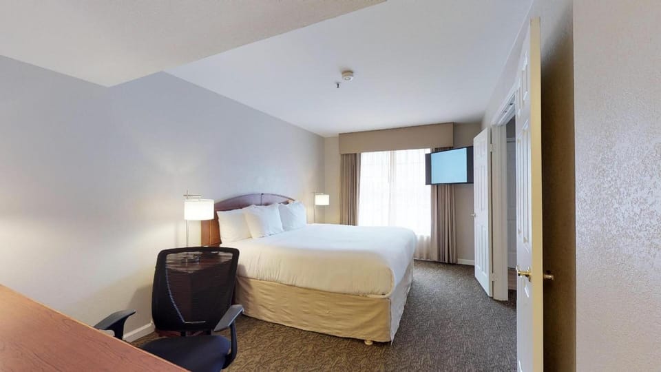 Unwind in a bright king bedroom with crisp linens.