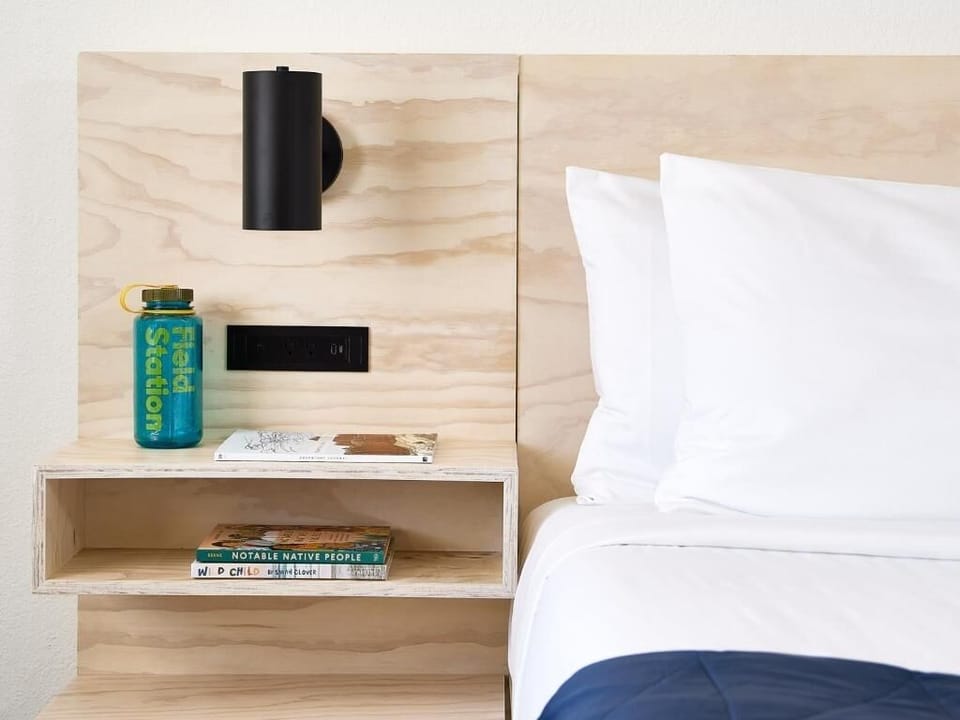 Sip morning coffee by the bed with thoughtful bedside touches.