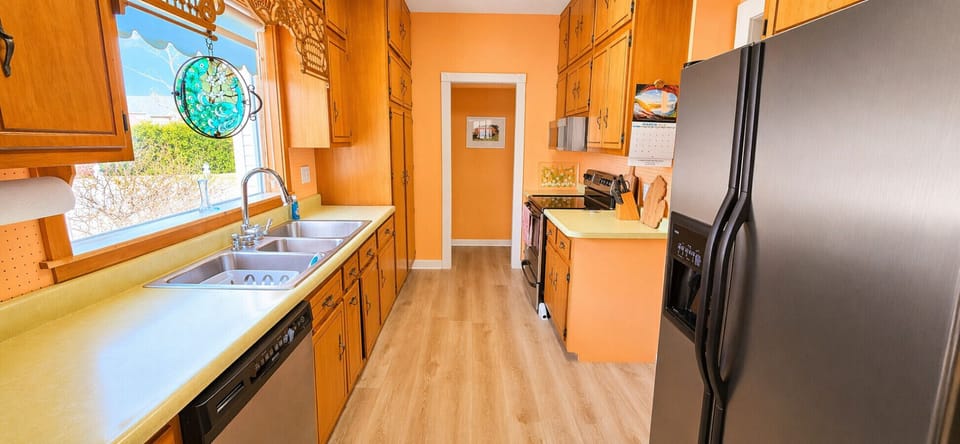 Galley kitchen with vintage charm, equipped for preparing meals during your stay.
