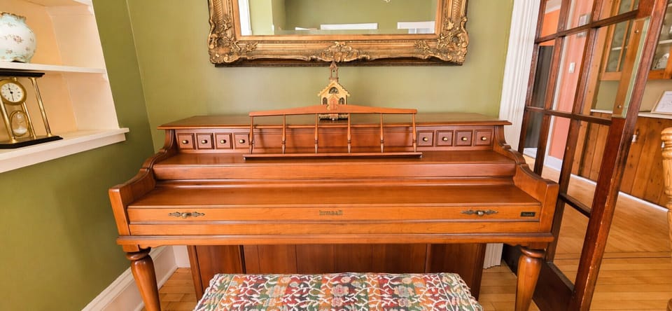 Kimball console upright piano available for guest use.