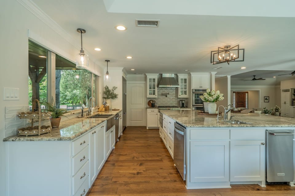 Bright kitchen with elegant granite countertops.

