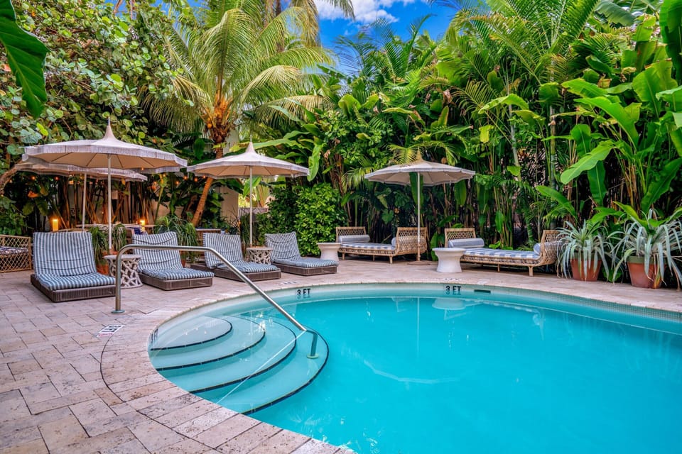 Soak up sunshine from shaded loungers by sparkling water