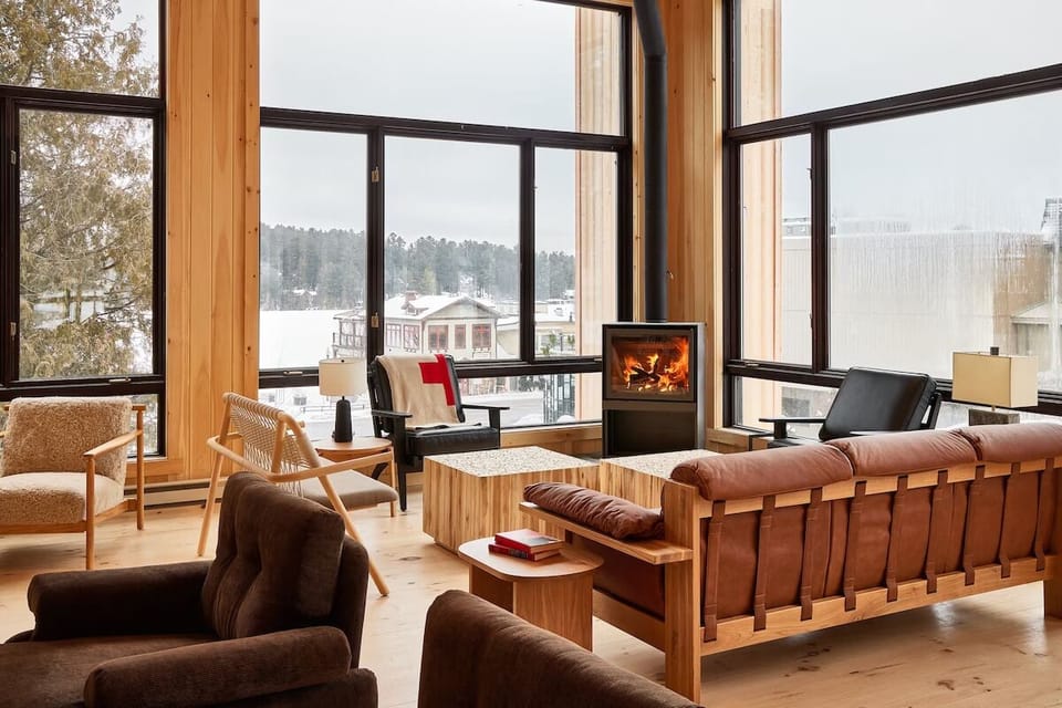 Settle by the glowing fireplace and watch snow drift outside.