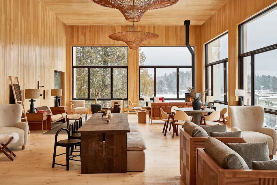 Unwind in the sunlit lounge with panoramic forest views.