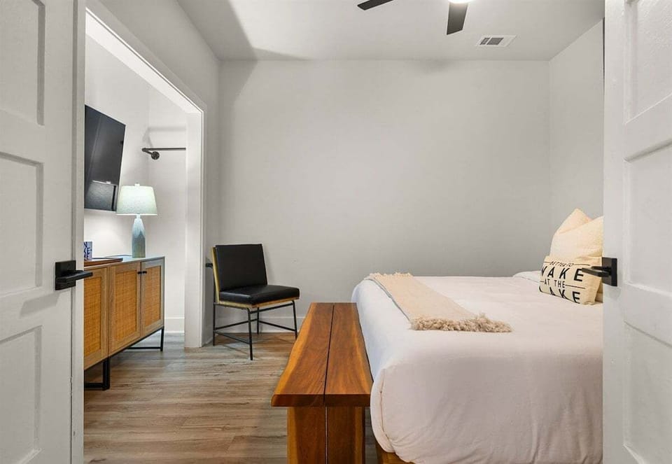 With warm accent walls and thoughtful details, this bedroom offers a comfortable and private retreat.