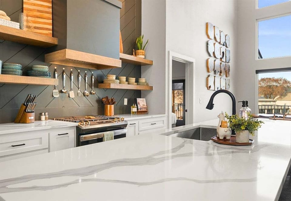 The bright and airy kitchen features high-end appliances, generous counter space, and an open design that keeps everyone connected.