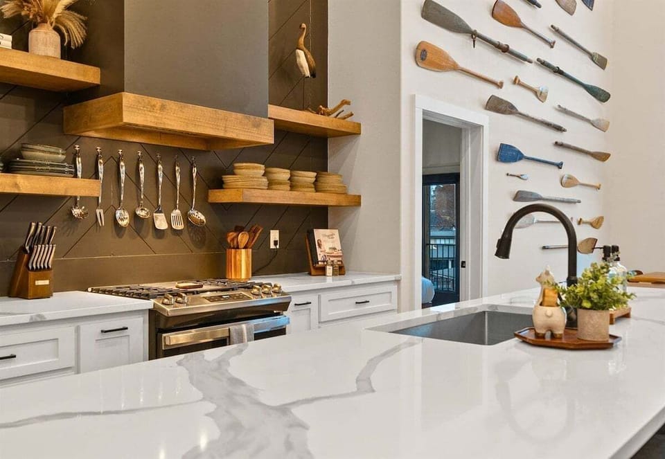 The bright and airy kitchen features high-end appliances, generous counter space, and an open design that keeps everyone connected.