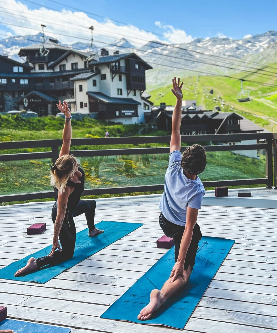 The residence terrace at 2,300m —yoga, fresh mountain air, and the Belleville Valley peaks in every direction.