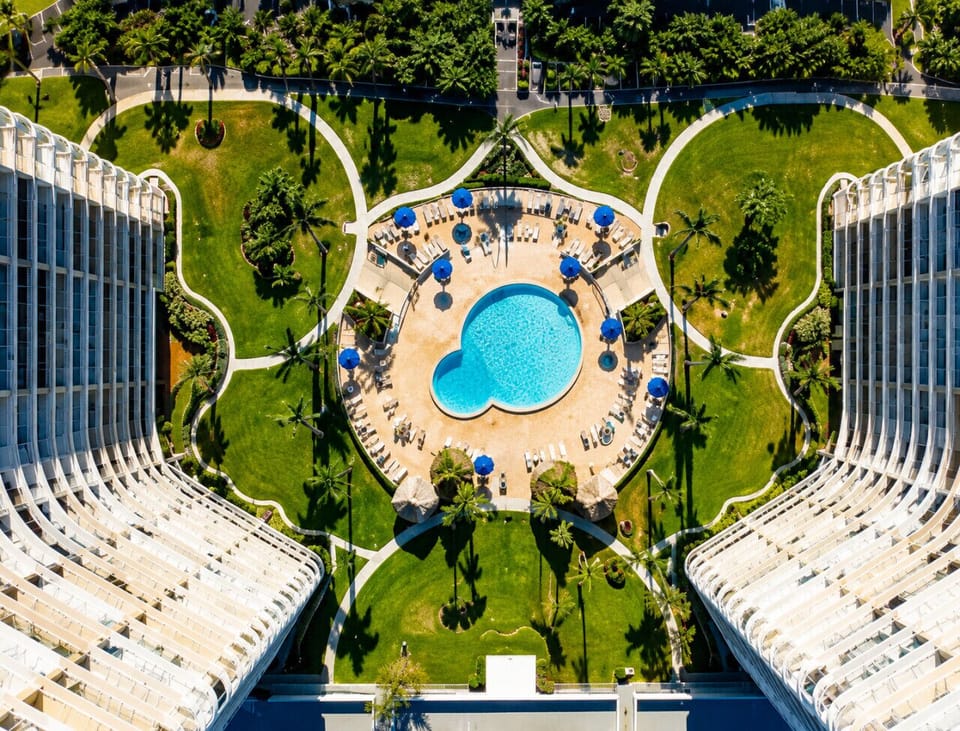 Symmetrical resort courtyard with pool
