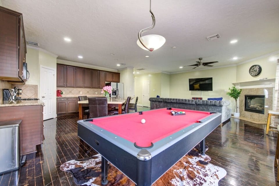 Spacious open-concept area featuring the living room, kitchen, dining space, and 8-ball pool.