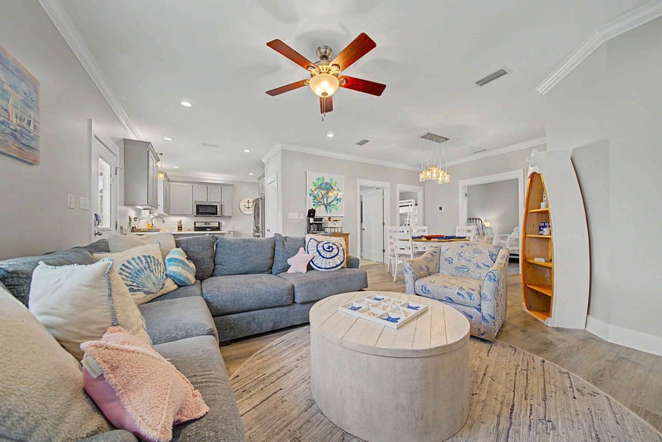 Bright coastal living room with open layout and stylish, comfy seating