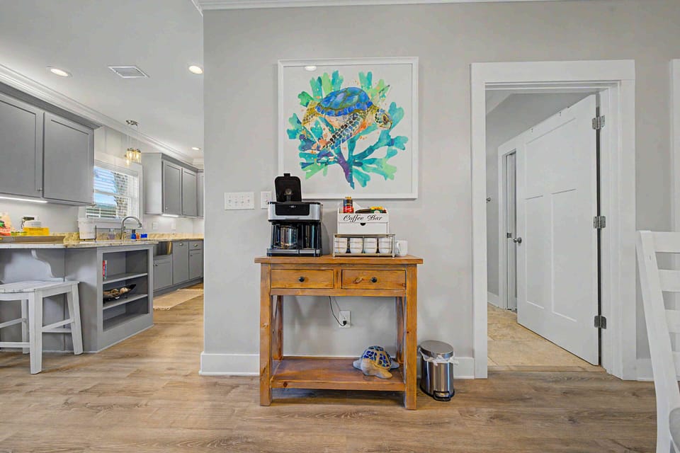 Coastal-inspired coffee nook beside a bright, modern kitchen