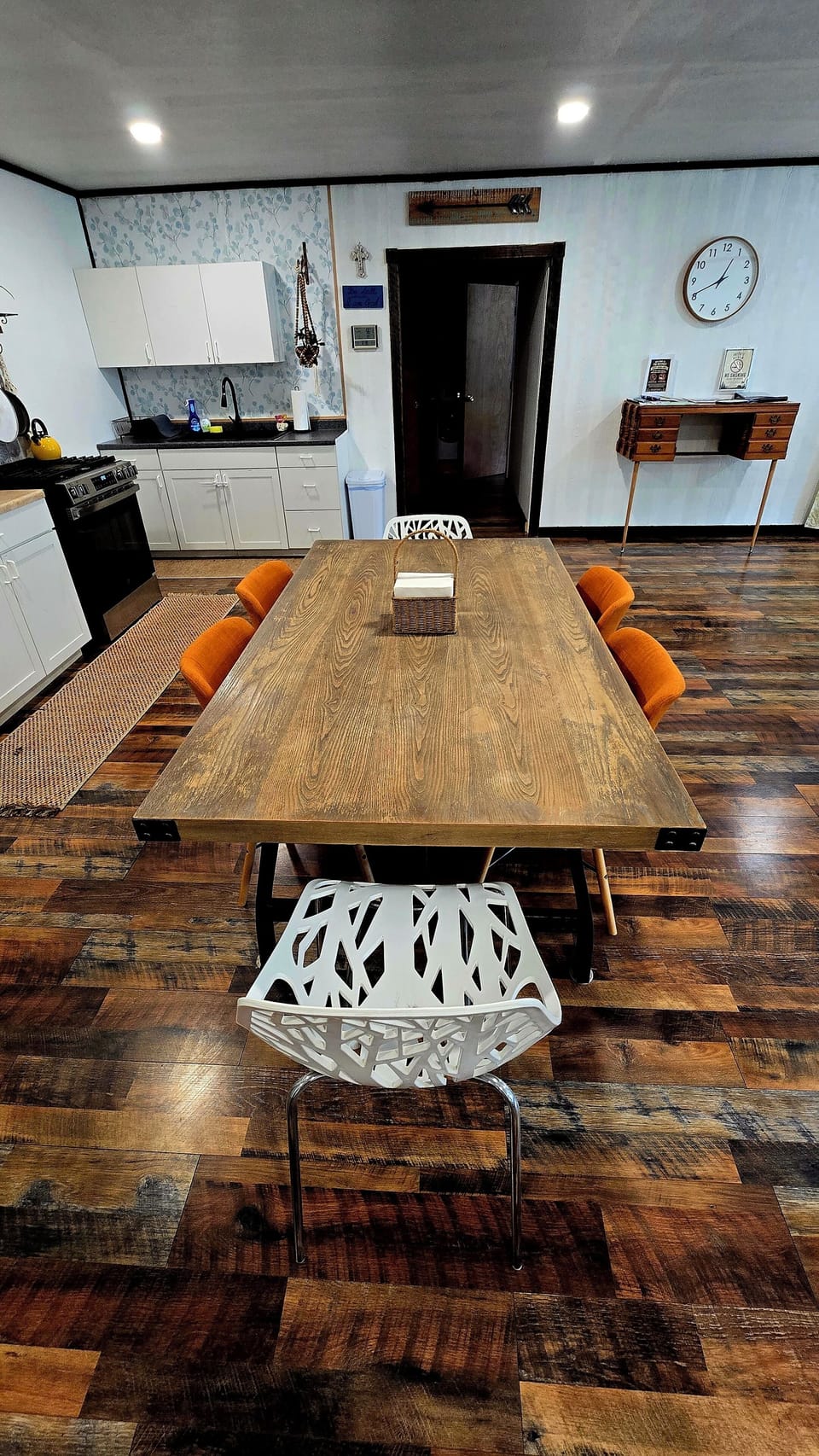 kitchen visible, indoor dining, indoor, oven, stovetop, dining table