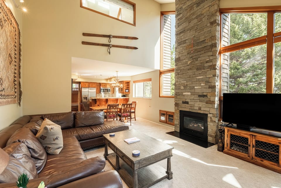 Warm and inviting living room with soaring ceilings and mountain lodge charm