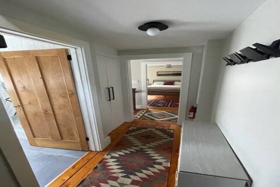 Charming entryway showing off beautiful wide-plank hardwood floors.